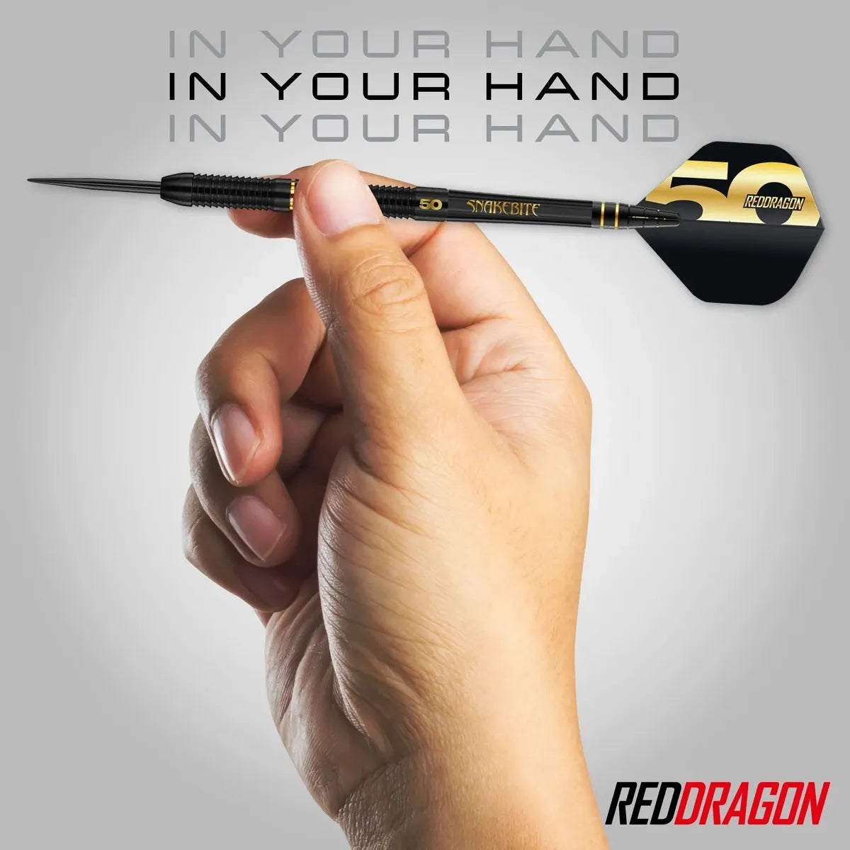 Hand holding a Peter Wright Limited edition dart with 'Red Dragon' branding on a gray background
