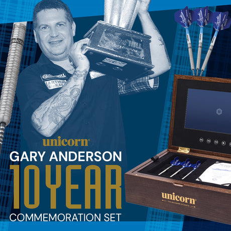 Gary Anderson holding a trophy, with a limited-edition dart set and commemorative wooden box.