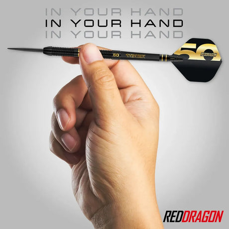 Hand holding a Peter Wright Limited edition dart with 'Red Dragon' branding on a gray background